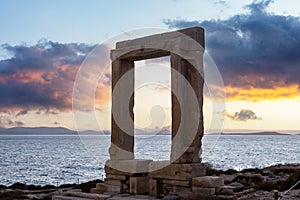 Naxos island, Greece. Sunset over Apollo Temple Cyclades Sea, cloudy sky background