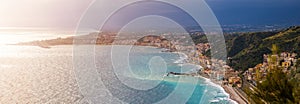 Naxxos, Sicily - Panoramic skyline view of Giardini Naxxos town and beach with turquoise sea water photo