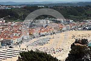 Nazare, Portugal - August 16, 2022: aerial view of the Praia de Nazare,Nazare Beach, and the city of Nazare, in the