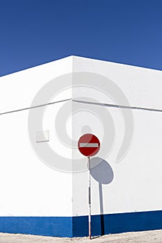 NAZARE, PORTUGAL - July 14, 2017. White wall with no entry traffic sign, against a blue sky. photo