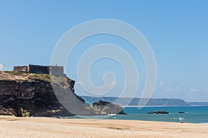 Nazare, Portugal - June 29, 2021: View of the fortification and lighthouse of Nazare from the North Beach