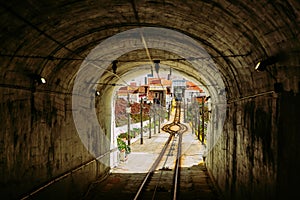 Nazare, Portugal: the narrow passage between buildings on Nazare Funicular line connecting two parts of the village