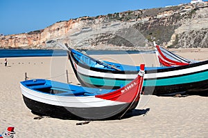 Nazare, Portugal - November 5, 2017: colorful traditional old wooden fishing boat on the beach of fishing village of Nazare .