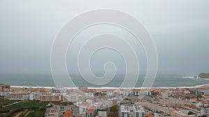 Nazare resort town with ocean scene and hotels on the coast, Portugal