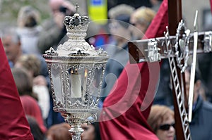 Nazarene wearing silver lantern in easter processi