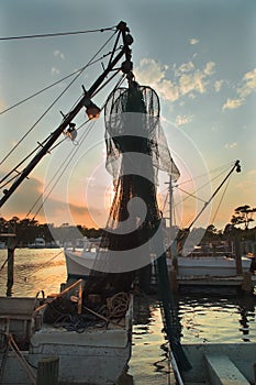 NC.USA. Boat silhouette. Picturesque sunset on river. Vertical photo.