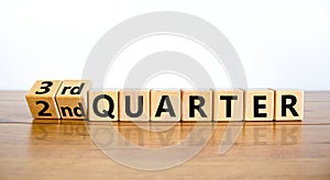 From 2nd second to third 3rd quarter symbol. Turned wooden cubes and changed words 2nd quarter to 3rd quarter. Beautiful wooden photo