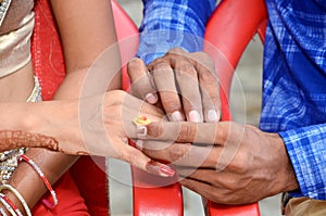 Ndian groom putting ring on indian bride