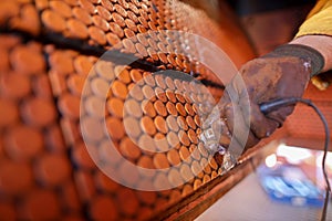 NDT inspector technician wearing safety glove protection standing holding UT thickness testing device photo