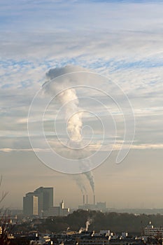 Industrial chimneys bellowing out smoke photo