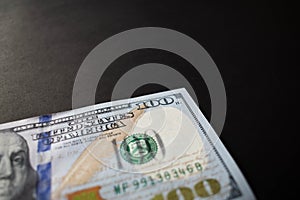 ne hundred dollar bill on black background photo