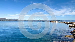 Nea Makri, Attica Greece. Panoramic view of vast Aegean calm sea with rocky formation in water