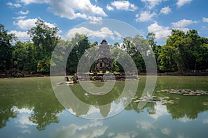 Neak Pean, temple tower in the middle of a pond, surrounded by the tropical forest in Siem Reap, Cambodia, spiritual ancient site.