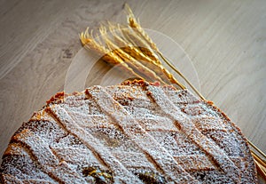 Neapolitan Pastiera Crostata, typical italian cake for Easter time exposed with ears of wheat.