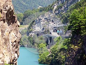 Near the bay with turquoise water, there is a road to the tunnel in the rock