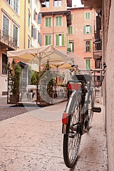 Near the entrance to the old house, in the old quarter of the city, there is a bicycle near the wall