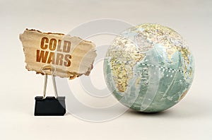 Near the globe there is a clip with a cardboard plate on which it is written - cold wars