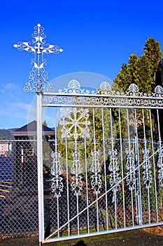 Silver cross on entrance gate of Masonic Cemetery, Canyonville, Oregon