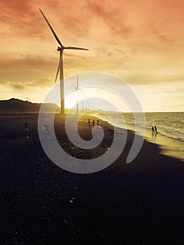 Near Silhouettes of wind turbines agaisnt the sun during sundown at Bangui, Ilocos Norte Philippines