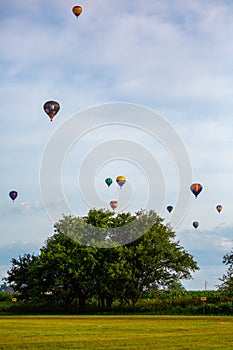 Near Wausau, Wisconsin, USA, July 10, 2021, Taste N Glow Balloon Fest. Hot air balloons fill the sky in central Wisconsin