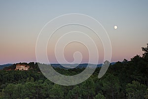 A Nearly Full Moon Over the Ochre Cliffs of Roussillon France