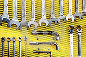 Neat arrangement of tools on yellow pegboard