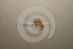 A neat cut of a brown sheet of paper taped