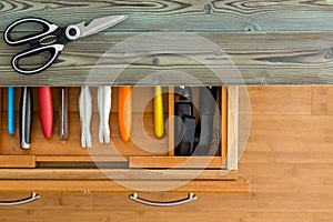 Neat line of colorful knives in a fitted drawer