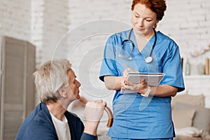 Neat mindful doctor hearing out her patient