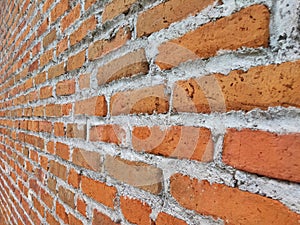 Neat and orderly pattern of red brick and cement arrangement on the walls of the house