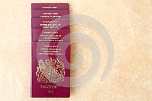 Neat pile of five British United Kingdom European Union Biometric passports with copyspace for text