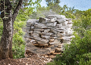 A neat pile of stones folded for the construction of the wall on the island of Lavsa, Croatia photo