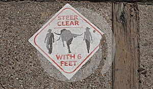 A sign on the sidewalk at the Fort Worth Stockyards in Fort Worth Texas. photo