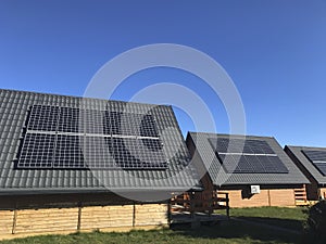 Neat solar panels on gray tin roof.