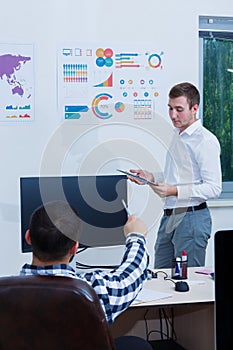 A neat and stylish office worker analyzes the schedule.