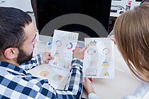 A neat and stylish office worker analyzes the schedule.