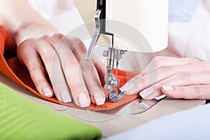 Neat tailor sewing a fabric