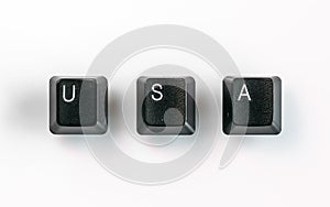 Neatly arranged computer keyboard keys spelling USA, isolated on white background