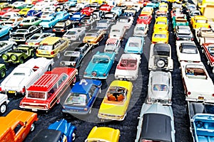 Neatly arranged rows of toy cars photo