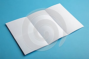 Template fold white paper on blue background photo