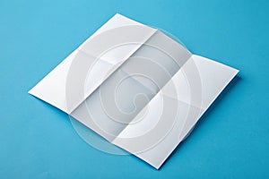 Template fold white paper on blue background photo