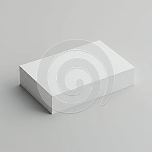 A neatly stacked pile of blank white paper rests on a smooth gray surface. The stack is