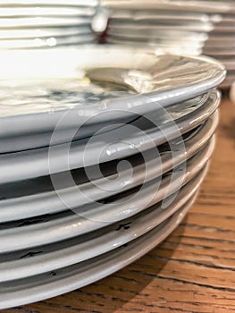 Stack of Clean White Plates on Wooden Tabletop