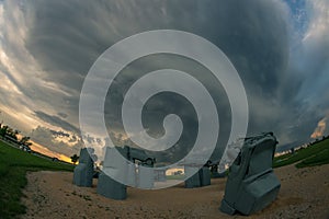 The Nebraska tourist attraction titled `Carhenge` with a severe thunderstorm in the background