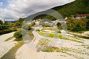 Nebug River. Mountains of the Caucasus. Forest plantations in the mountains. The river goes into the mountains. Houses