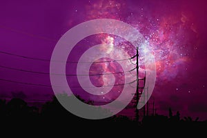 nebula floats in night sky above the shadow of an electric pole