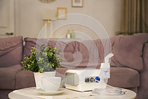 Nebulizer on the coffee table near the sofa in the room