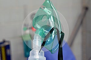 A nebulizer or nebuliser mask that is connected to oxygen cylinder or a drug delivery device used to administer medication in the