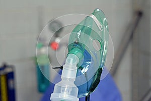 A nebulizer or nebuliser mask that is connected to oxygen cylinder or a drug delivery device used to administer medication in the