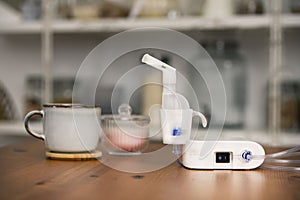 Nebulizer on the table with a cup and sugar bowl